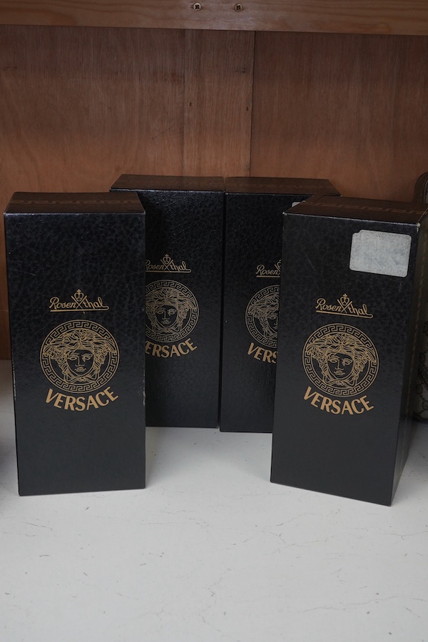 Four boxed Rosenthal for Versace Medusa head grappa glasses in various colours, 21.5cm high. Condition - good.